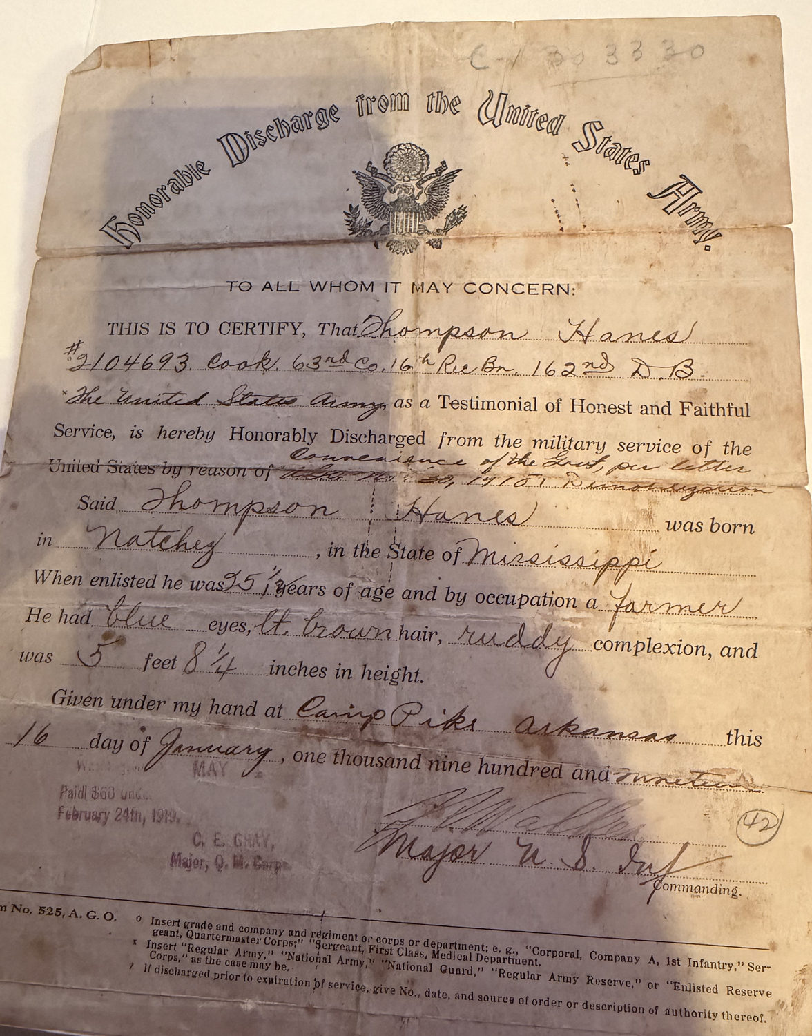 A worn, folded 1919 certificate headed Honorable Discharge from the United States Army, filled in by hand for Thompson Hanes, serial number 2104693, Cook, 63rd Company, 16th Recruit Battalion, 162nd Depot Brigade, born in Natchez, Mississippi, discharged at Camp Pike, Arkansas, on January 16, 1919.